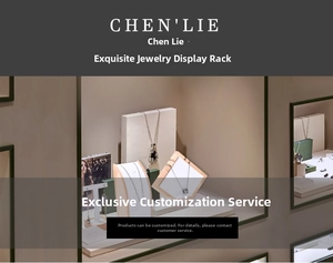 Close-up of wooden and white jewelry display set for necklaces and earrings in a shop