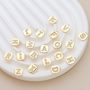 Macro view of gold-plated alphabet pendant with cubic zirconia for DIY jewelry