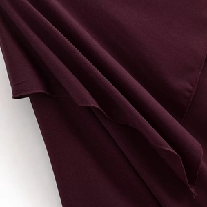 Macro shot of soft burgundy fabric showing fine texture and elegant drape detail