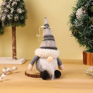Close-up of a Christmas gnome ornament with a striped knit hat on a wooden tray