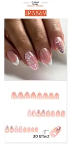 Detail view of French tip press-on nails with 3D white heart embossed patterns and glitter