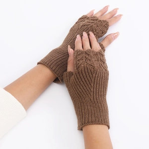 Detailed view of brown cable knit fingerless gloves showing high-quality wool texture