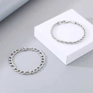 Detail showing textures of silver Figaro and twisted rope chain bracelets for men