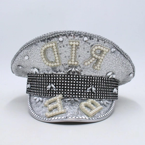Detailed close-up of a silver sequin captain hat with pearl letters and rhinestone trim