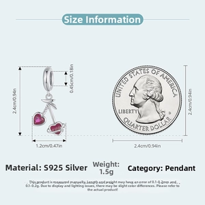Detail of S925 silver cherry pendant with red heart crystals next to a coin for scale