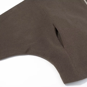 Macro view of dark brown polar fleece fabric texture and premium metal zipper detail