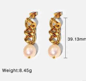 Golden CCB link chain drop earrings with a large white pearl bead on white background