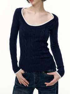 Detail of slim-fit cable-knit wool sweater in navy with white contrast piping details