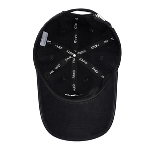 Internal view of black cotton baseball cap showing brand webbing and wash label