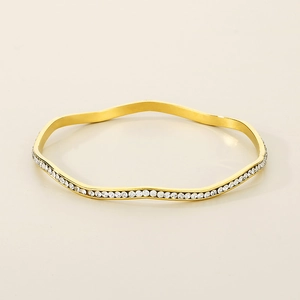 Close-up of gold wavy titanium steel bracelet with full micro-pave cubic zirconia inlay