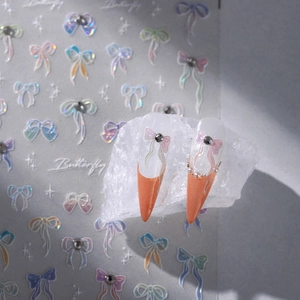 3D butterfly nail stickers with iridescent bows and pearl accents on display