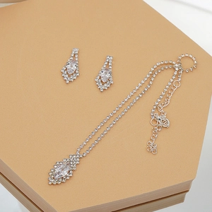 Detailed view of silver zircon bridal jewelry set with necklace and drop earrings