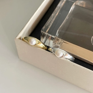 Minimalist S925 silver and gold pearl rings shown in a luxurious jewelry box setup