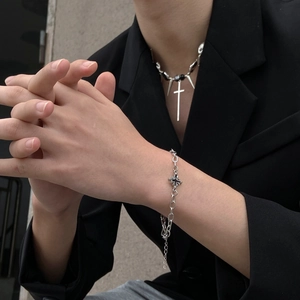 Punk silver cross and rivet necklace with gothic star bracelet on black suit