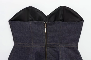Detail of dark blue denim corset top featuring a back metal zipper and black lining