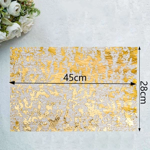 Detail view of gold foil mesh table mat with dimensions 45x28cm for elegant wedding decor