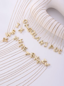 Detailed macro view of 18K gold plated balloon style alphabet pendants and box chains