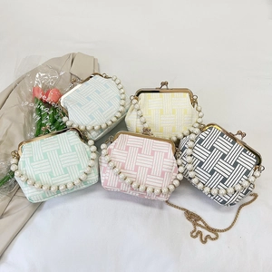 Shell-shaped woven crossbody bags in pastel colors with pearl handle and metal clasp