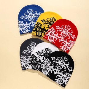 Close-up of knit beanies in six colors featuring gothic cross print on soft fabric