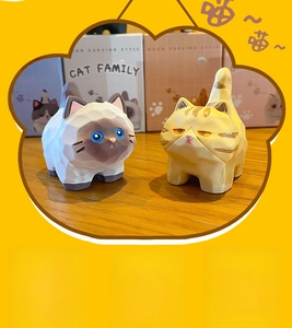 Detail of wood carving style cat resin figurines with geometric textured finish