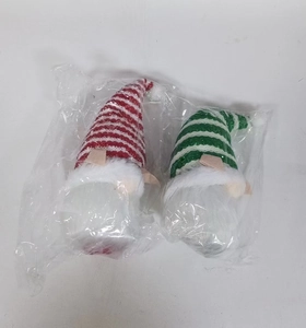Set of two Christmas gnomes with striped hats and white beards in clear packaging