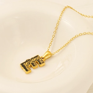 Modern 18k gold plated letter E pendant necklace with black enamel inlay on white plate