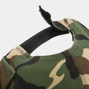 Close-up of camouflage docker hat featuring adjustable velcro strap and canvas texture