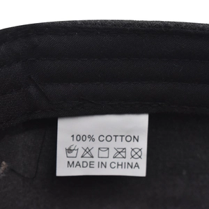 Detailed view of the 100% cotton fabric and washing care label inside the baseball cap