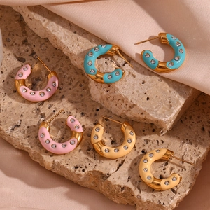 Detail showing colorful enamel C-shape hoop earrings with inlaid sparkling cubic zirconia