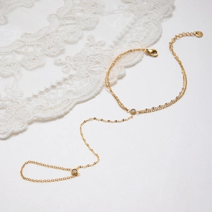 Detail view of 18k gold-plated stainless steel slave bracelet with sparkling zircon stones