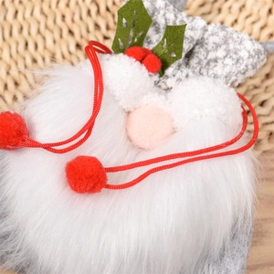 Detail of plush Christmas gnome gift bag with fuzzy beard and red knitted texture