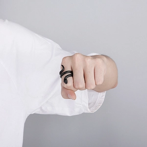 Close-up of a vintage black cobra snake ring worn on hand for a retro punk style look