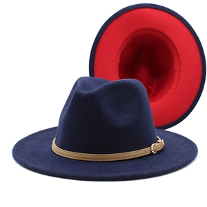 Detail of wool fedora hat with wide brim, red lining, and brown leather strap buckle
