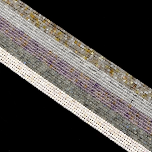Multiple strands of 2.5mm square natural crystal agate beads in assorted colors on black