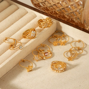 Set of gold-plated stainless steel rings with celestial patterns and zircon inlays