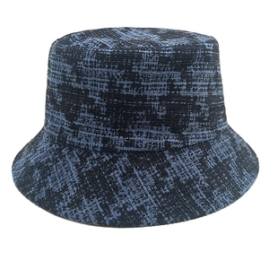 Blue and black houndstooth pattern bucket hat with textured knit fabric on white background