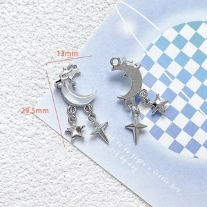 Macro detail of silver moon and star pendant with 13mm by 29.5mm dimensions