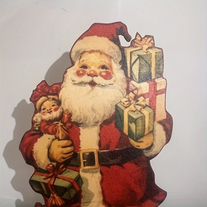 Detail of vintage wooden Santa Claus tabletop ornament with classic red and green colors