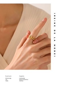 Macro detail of 18K gold plated stainless steel Cuban chain ring worn on a finger