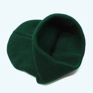 Detailed view of the fine rib knit texture and dark green wool blend fabric of the beanie