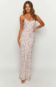 Detail shot of summer floral maxi dress with white base and delicate pink flower print