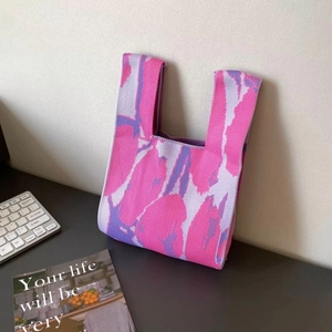 Close-up of pink and purple knitted tote bag with abstract jacquard pattern detail