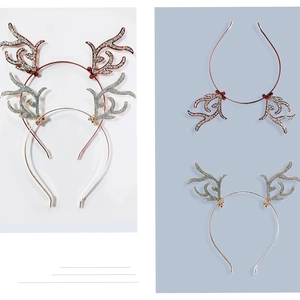 Detail of Christmas reindeer antler headbands with red berries and silver glitter finish