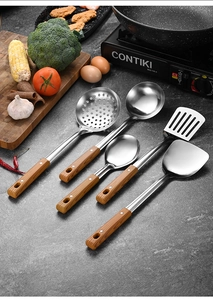5-piece stainless steel kitchen utensil set with wooden handles on a professional kitchen counter