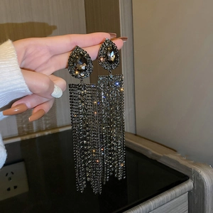 Detail shot of long tassel drop earrings with sparkling black waterdrop rhinestones