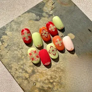 Detailed view of bohemian style press-on nails with floral patterns on stone base