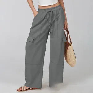 Detail of dark grey wide-leg cargo pants featuring adjustable drawstring and flap pockets