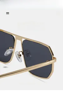 Detail of pilot sunglasses showing golden metal double bridge and dark grey lenses