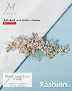 Detail of handmade bridal hair comb with gold leaves, pearls and crystal rhinestones