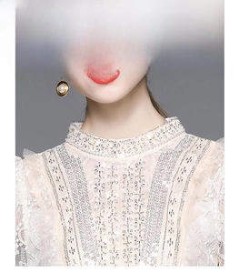 Detail of high neck lace dress with intricate floral embroidery and shimmering sequins